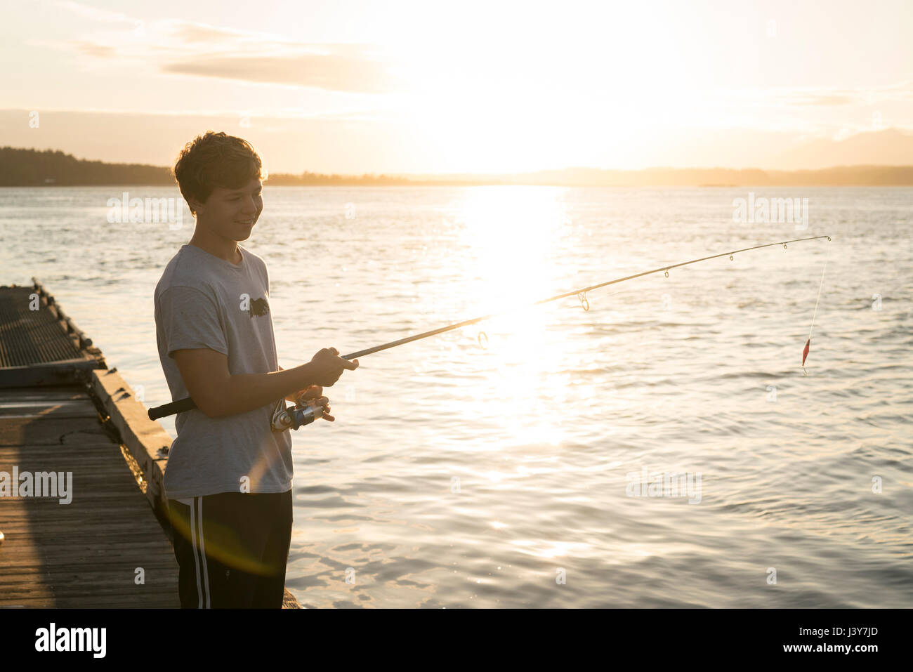 Teenage boy fishing, Pacific Rim National Park, Vancouver Island, Canada Stock Photo