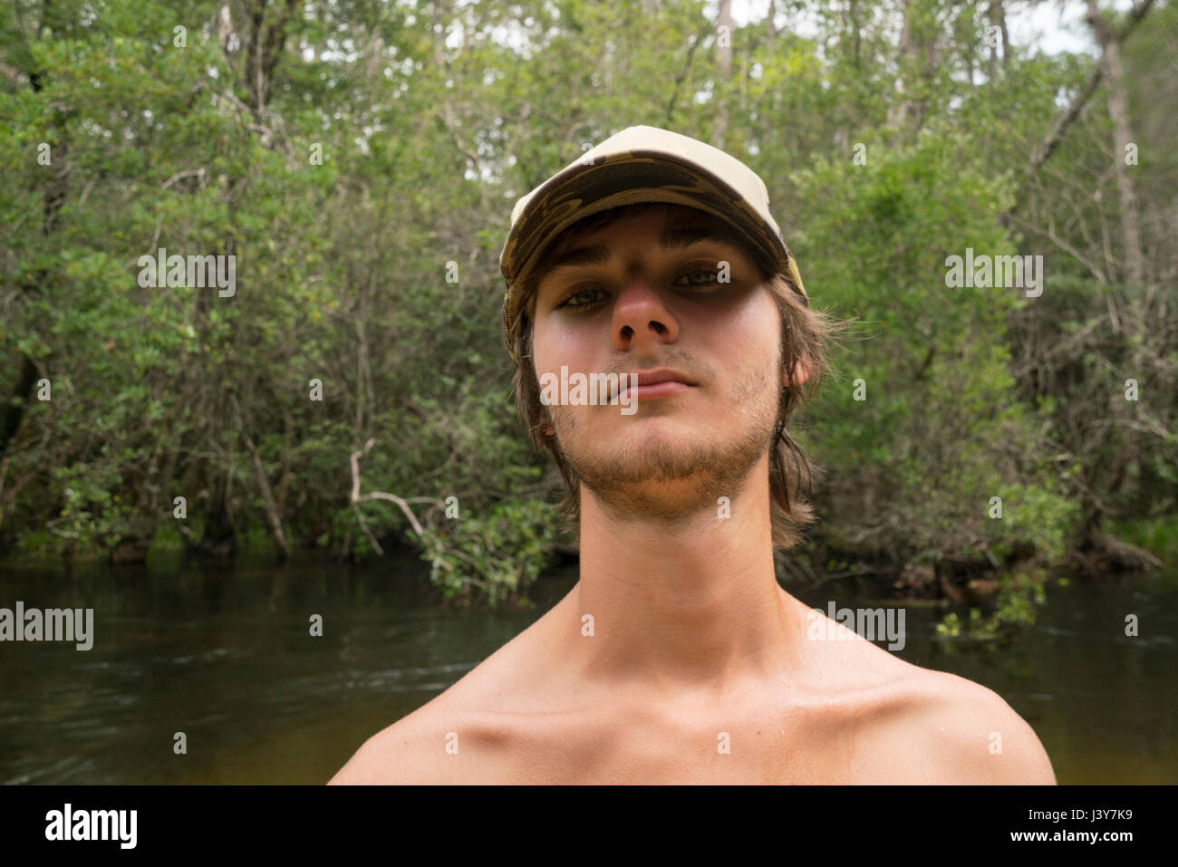 Portrait of teenage boy wearing baseball cap looking at camera Stock Photo