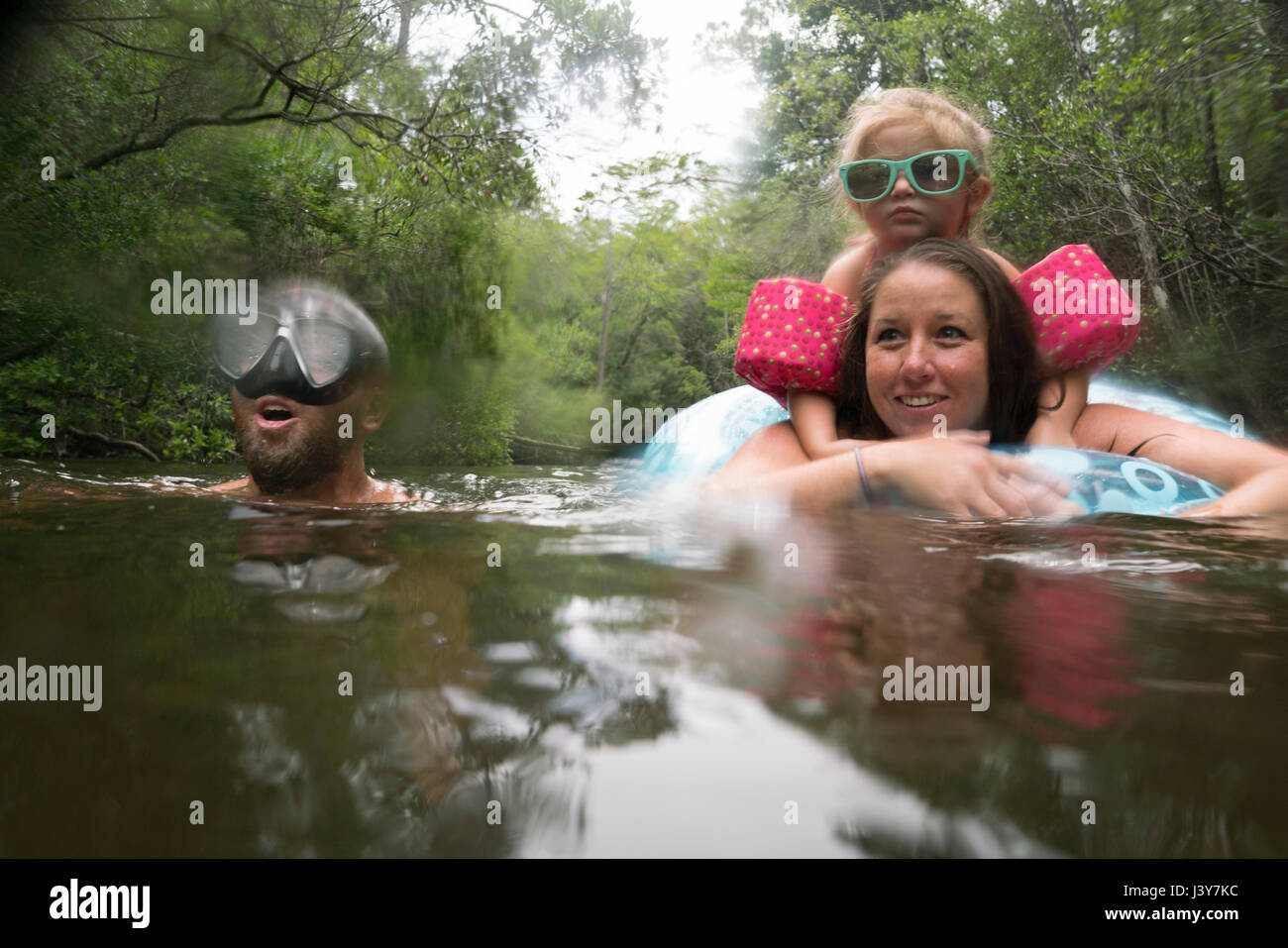 Mother, father and daughter with inflatable ring in lake, Niceville, Florida, USA Stock Photo