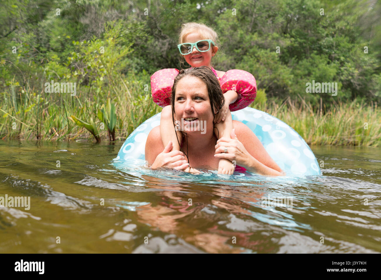 Mother and daughter with inflatable ring in lake, Niceville, Florida, USA Stock Photo