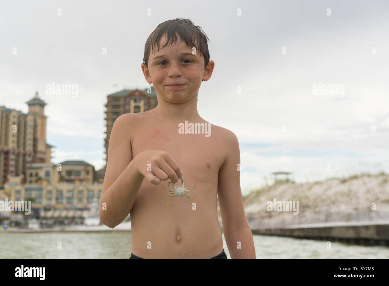Boy holding blue crab, Gulf of Mexico, Emerald Coast, Florida, USA Stock Photo