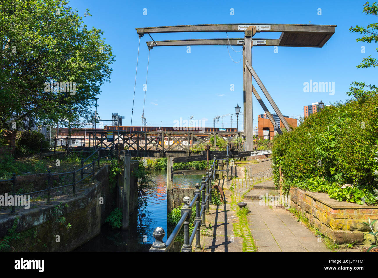 Bascule bridge at the lock on the Manchester and Salford Junction Canal where it joins the River Irwell, Manchester, England, UK Stock Photo