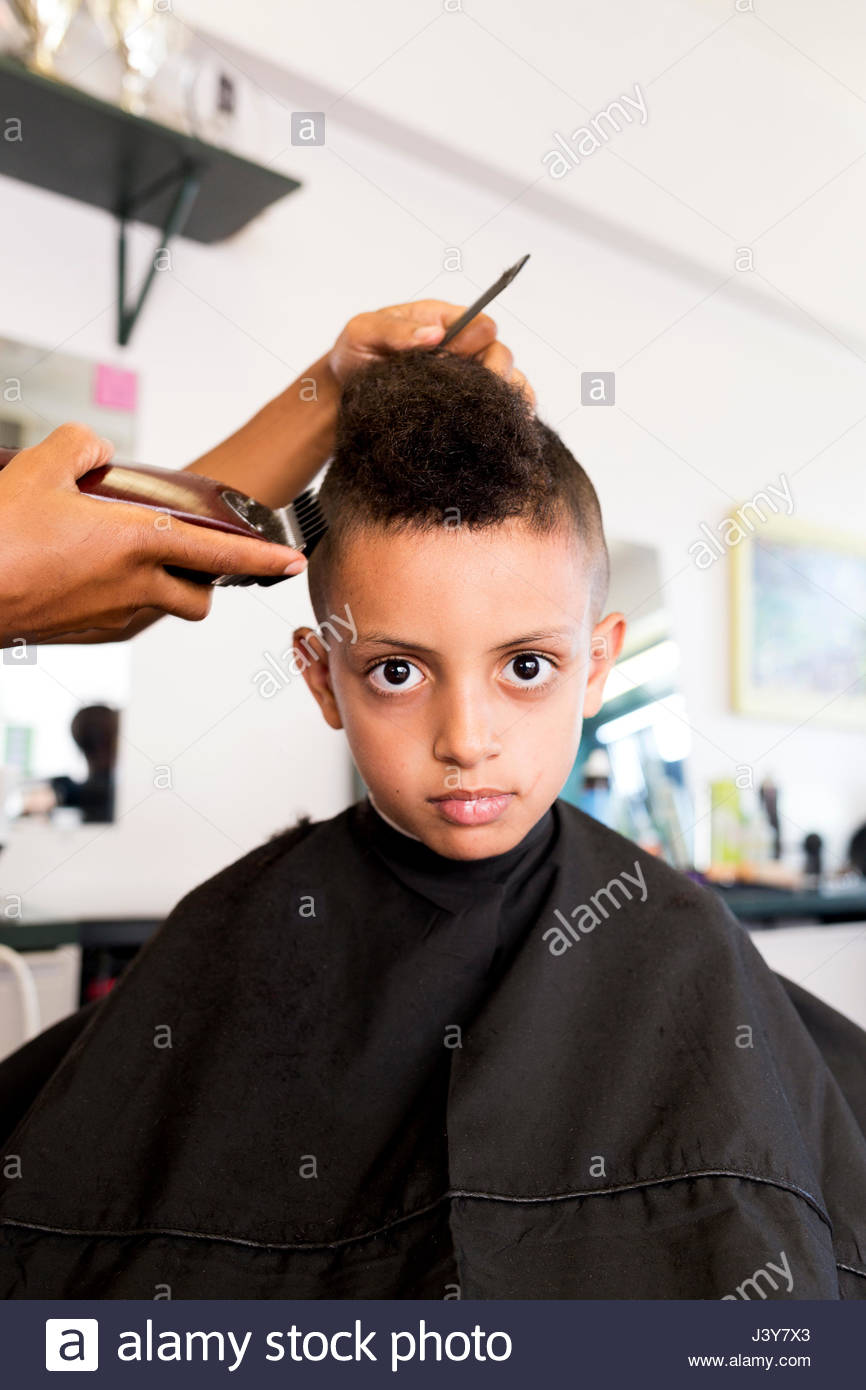 Female Barber S Hands Using Hair Clippers On Boy S Hairstyle In