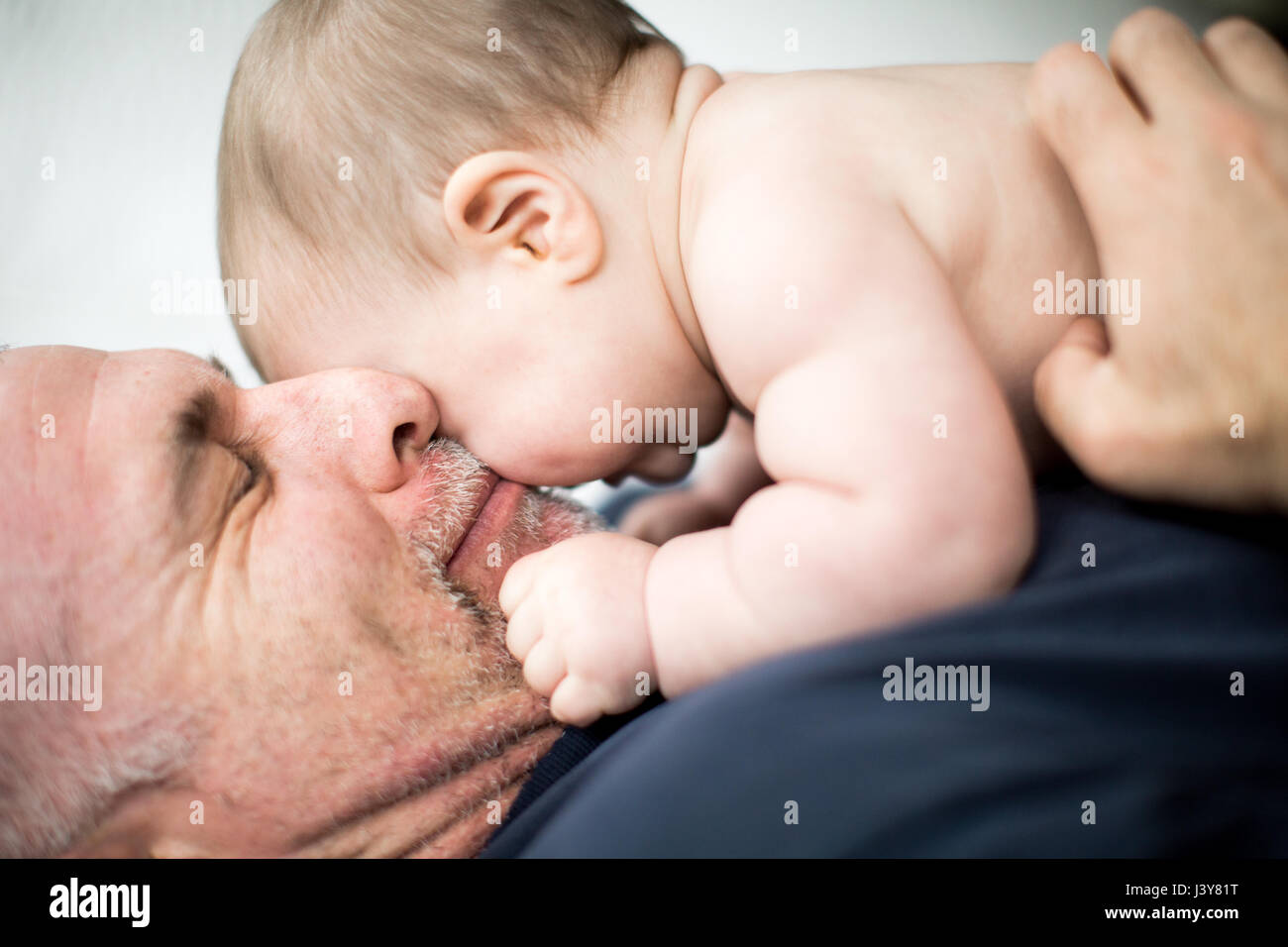 Mature man hugging baby daughter Stock Photo