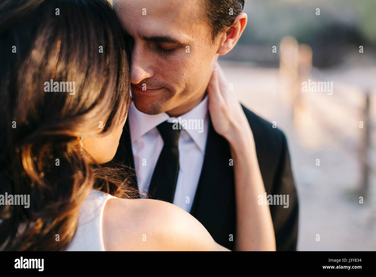 Mid adult couple outdoors, in romantic embrace Stock Photo