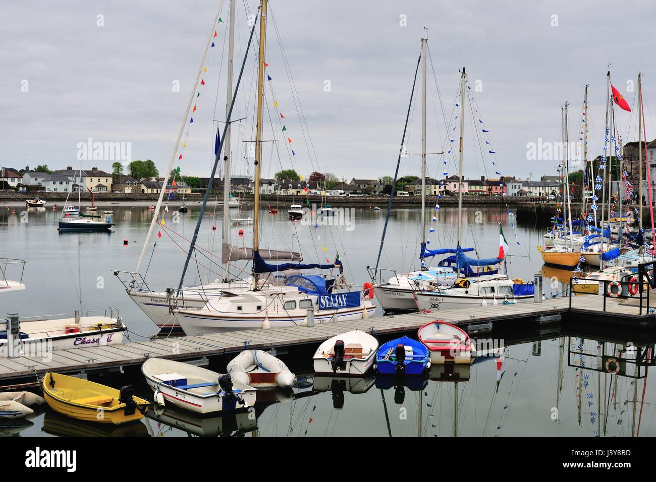 Small boats and sailboats in Dungarvan Harbor in the Irish coastal community of Dungarvan in County Waterford. Dungarvan Harbor is an inlet from St. G Stock Photo