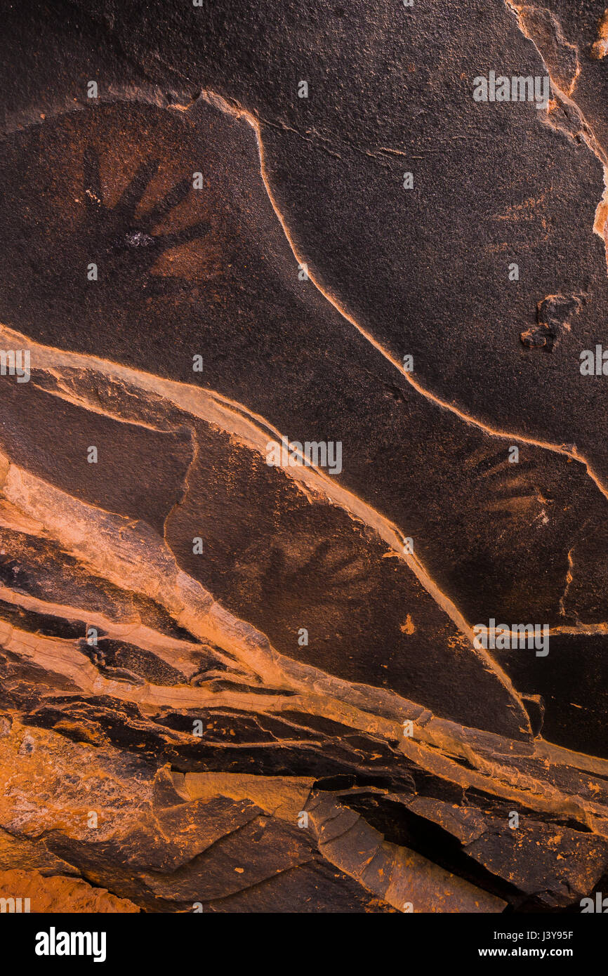 Spatter prints of human hand on the sandstone walls behind Fallen Roof Ruin, with its dramatic evidence of Ancestral Puebloan habitation, Bears Ears N Stock Photo