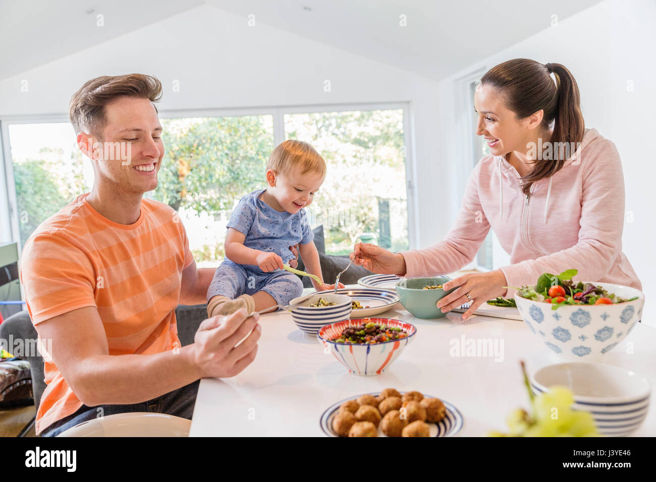 Young family having breakfast in the kitchen at home Stock Photo
