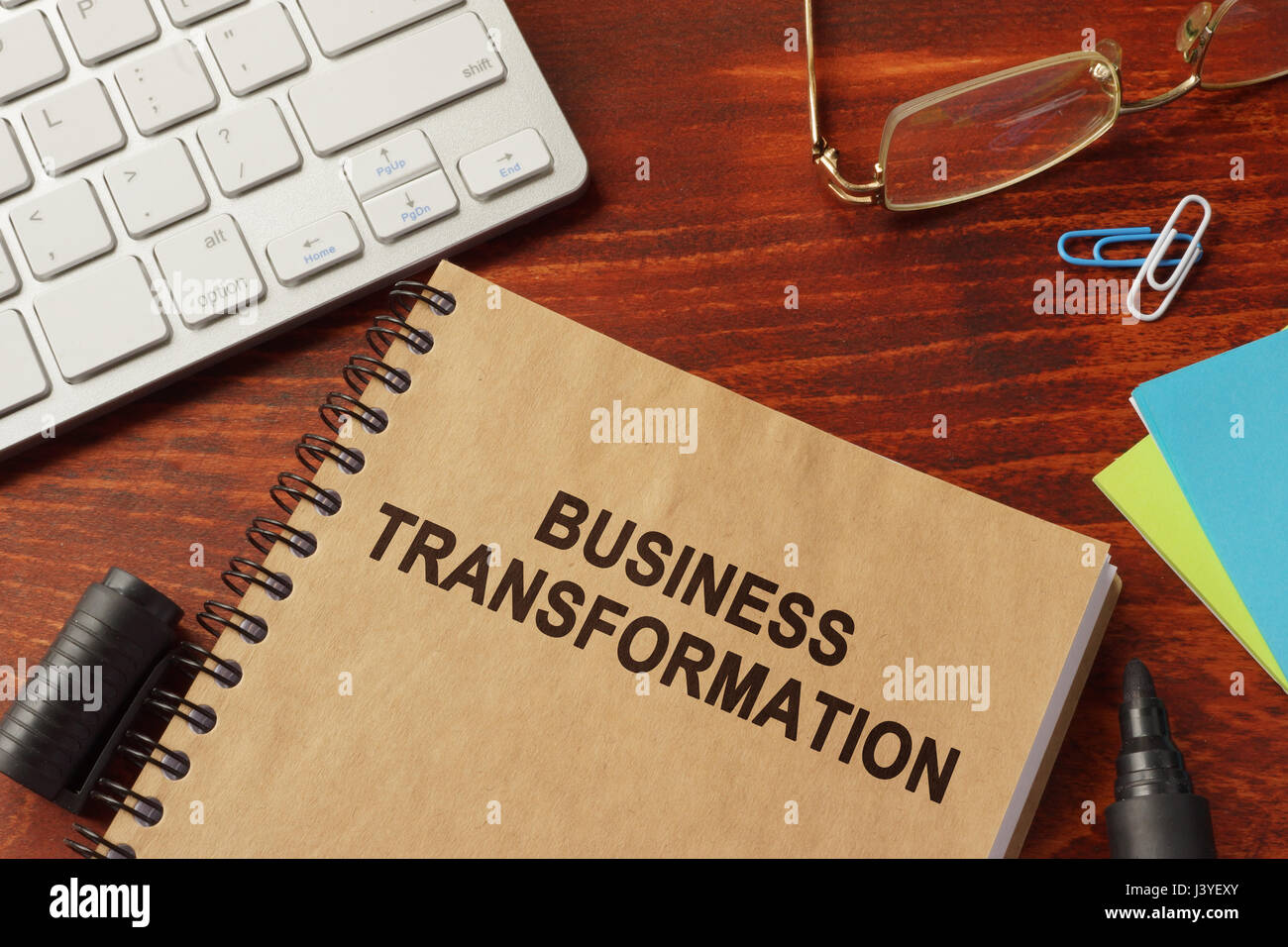 Book with title business transformation in an office. Stock Photo