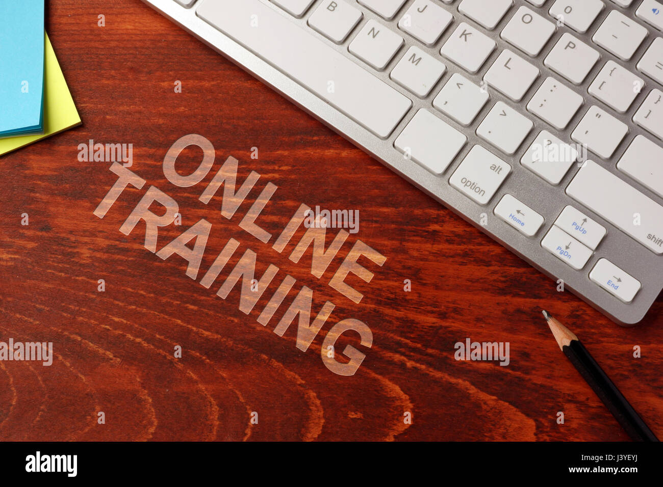 Online training written on a wooden surface. E-learning concept. Stock Photo