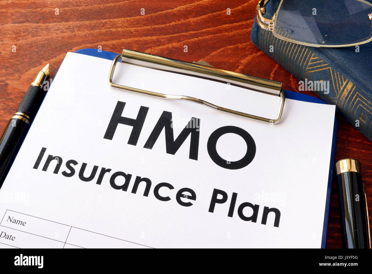 HMO Insurance Plan on a table. (Health Maintenance Organization) Stock Photo