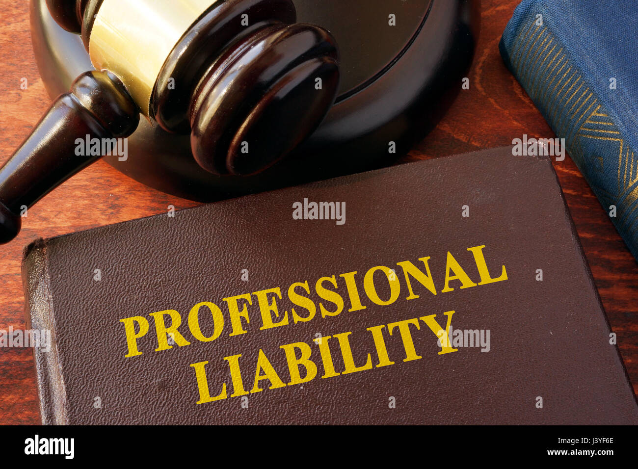 Book with title professional liability and gavel. Stock Photo