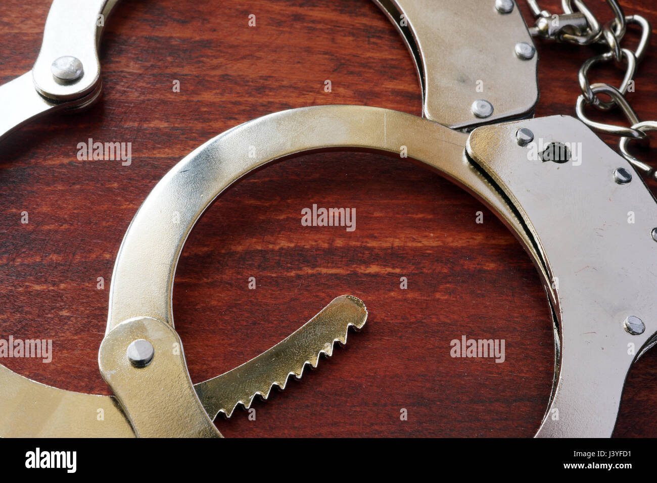Handcuffs on the table. Punishment and crime conept. Stock Photo