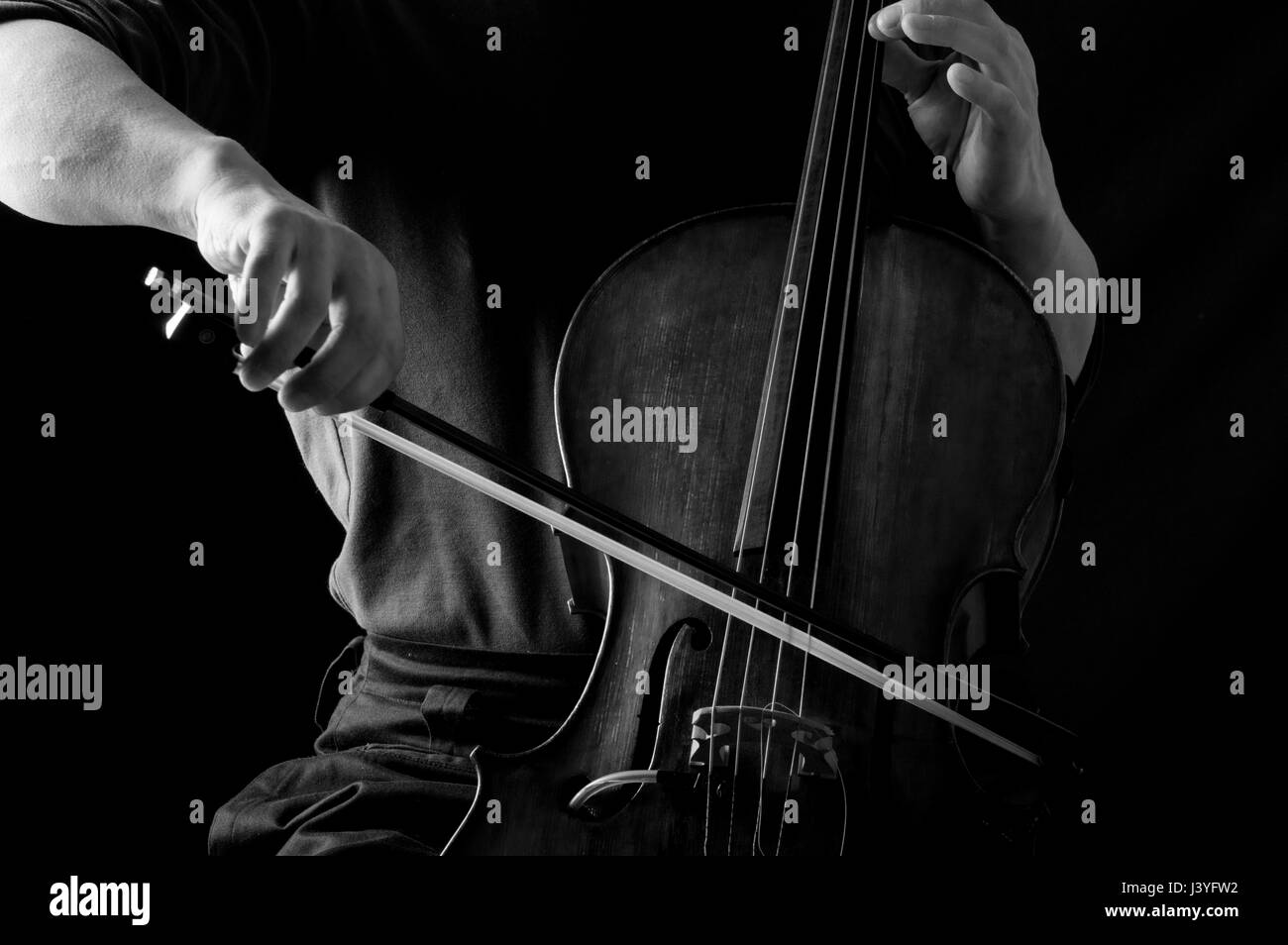 Black and white photograph of a man in playing bass with his face hidden Stock Photo