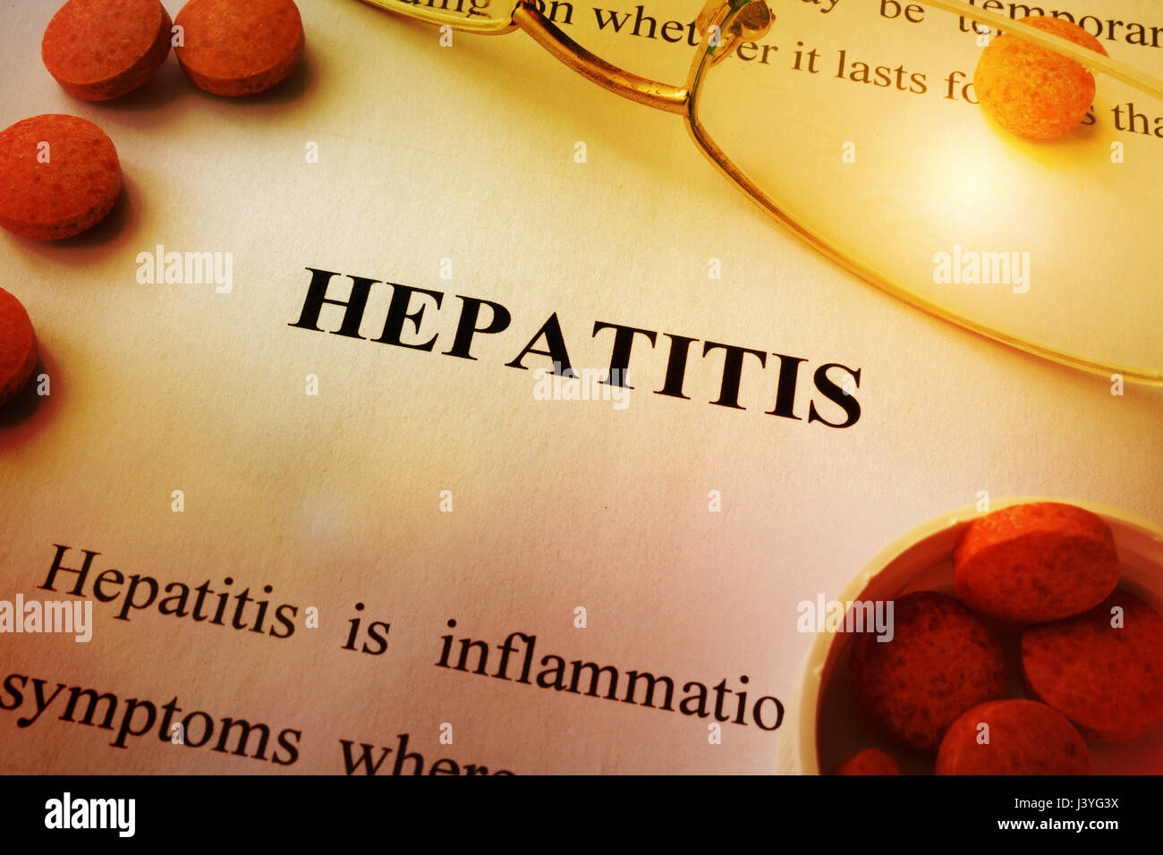 Page of book with title Hepatitis and tablets. Stock Photo