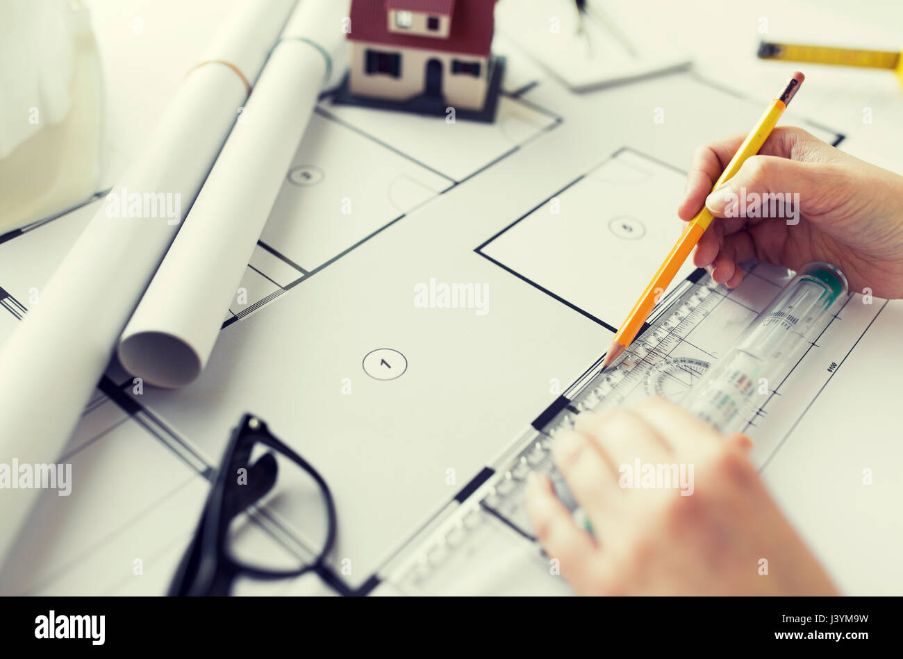close up of hands with ruler measuring blueprint Stock Photo - Alamy
