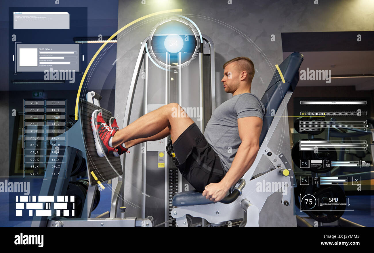 man flexing leg muscles on gym machine Stock Photo Alamy