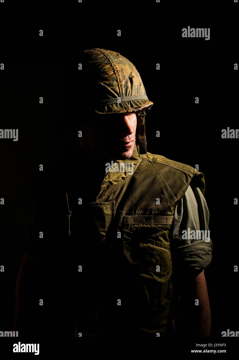 Dramatic portrait of US marine from the Vietnam War in dark shadows. Stock Photo