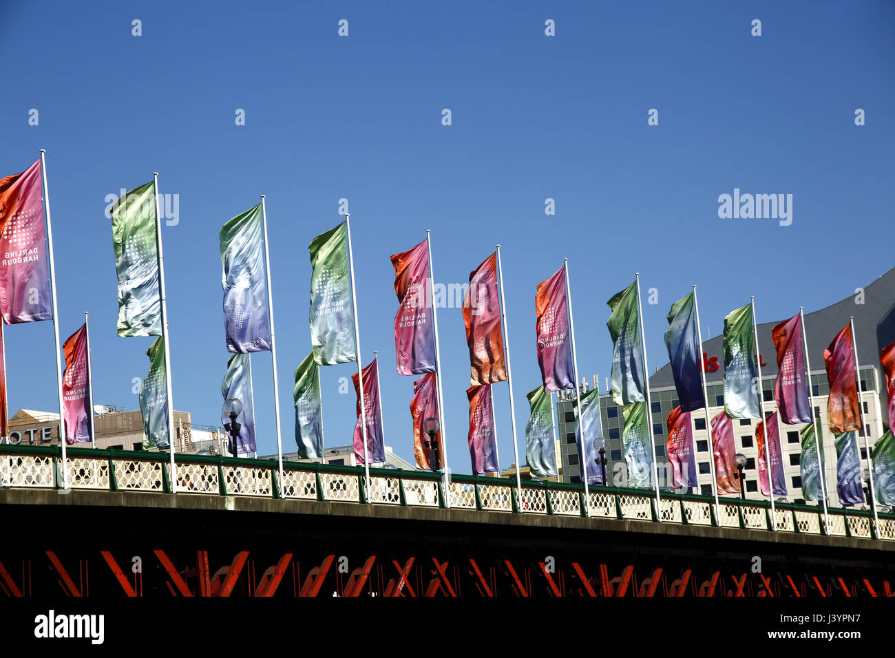 Flags flying over Pyrmont Bridge, Darling Harbour, Sydney Stock Photo