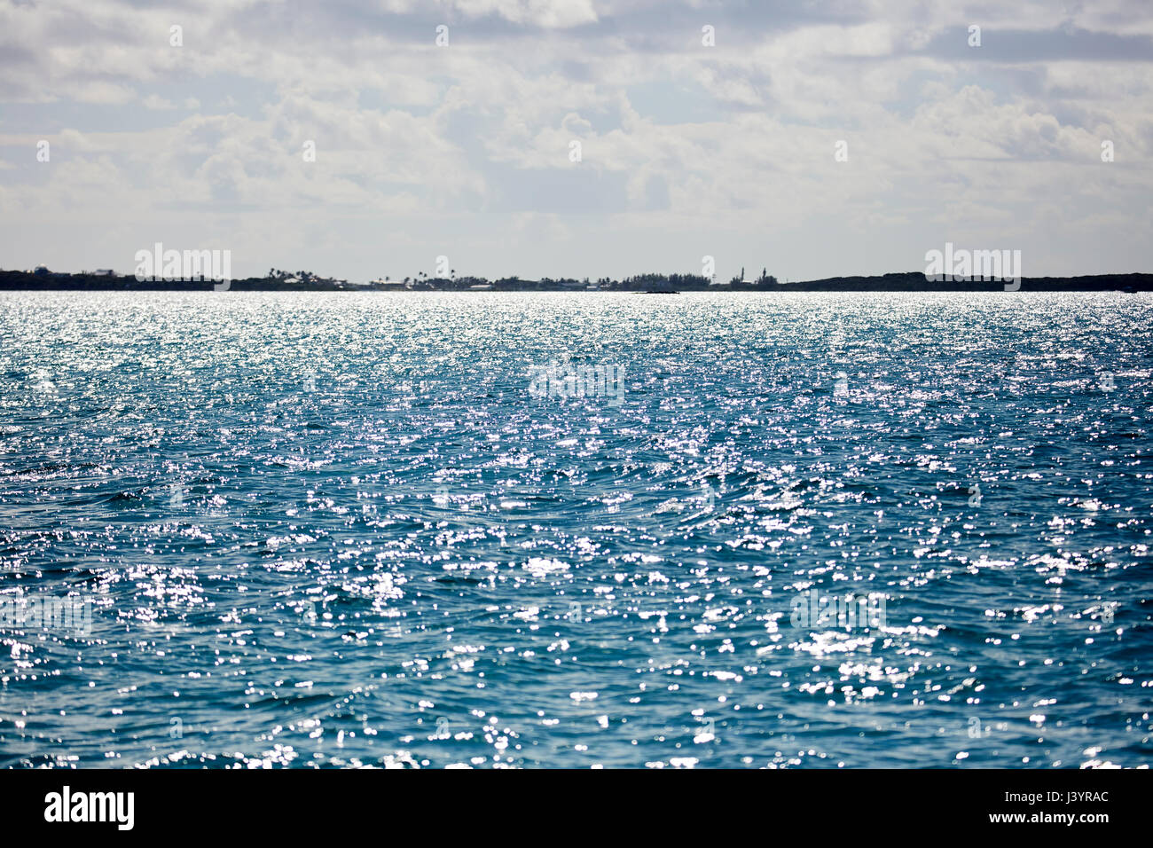 Glittering waters with island horizon Stock Photo