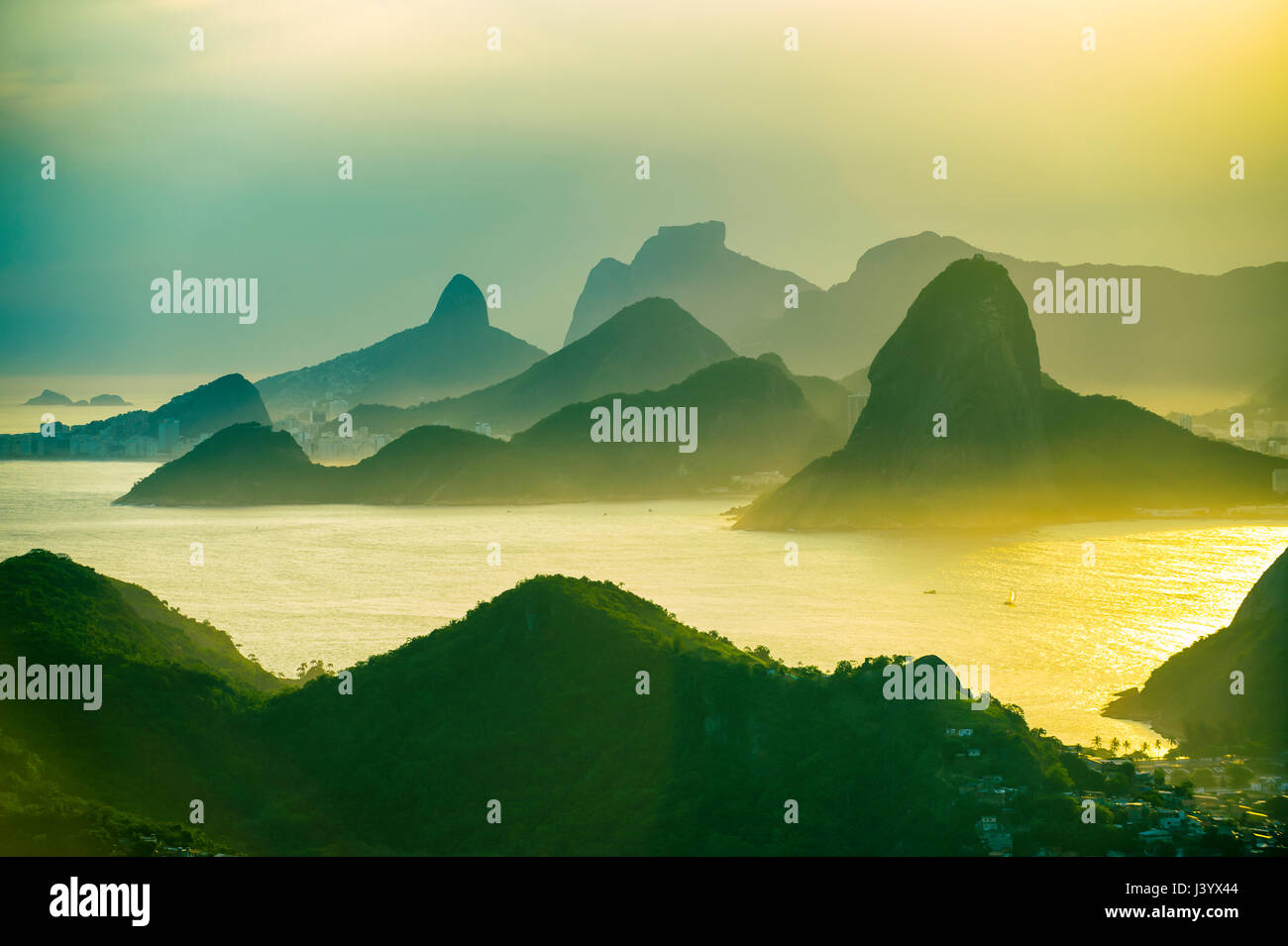 Golden sunset scenic view of the mountainous skyline of Rio de Janeiro, Brazil with Guanabara Bay Stock Photo