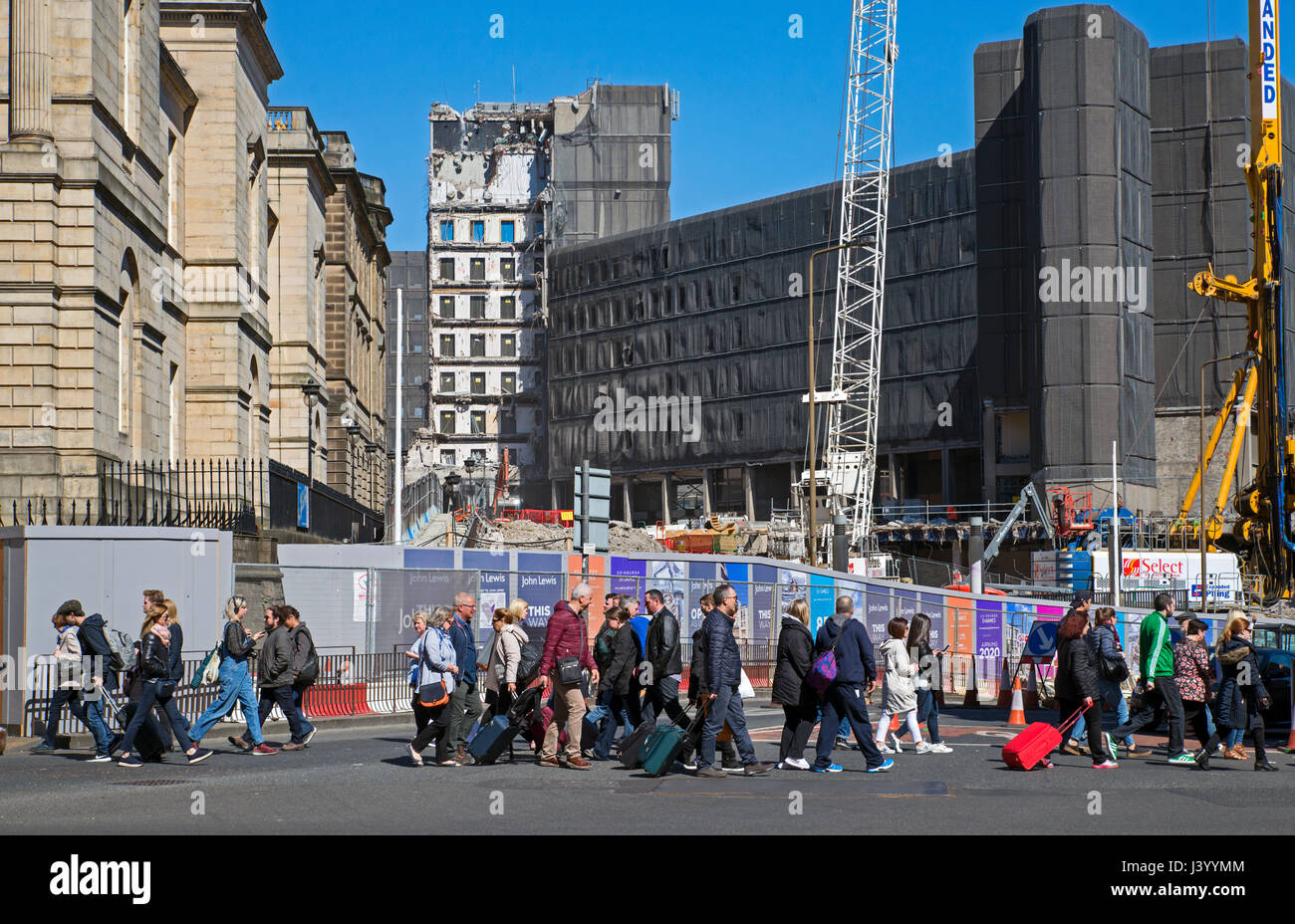 Pedestrians walk by the St James Centre which is being demolished to make way for a new hotel, shops and appartments. Stock Photo