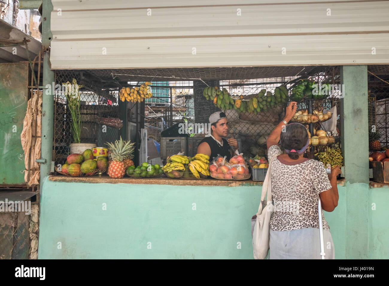 Woman choosing fruits at typical vegetables and fruits market stand in Havana, Cuba Stock Photo