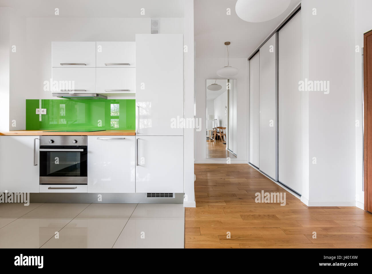 Open space with small modern kitchen in new flat Stock Photo - Alamy