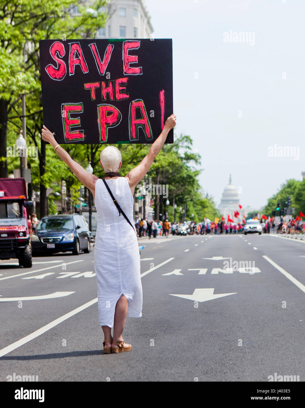 Climate change activist holding 'SAVE the EPA' sign in protest - USA Stock Photo