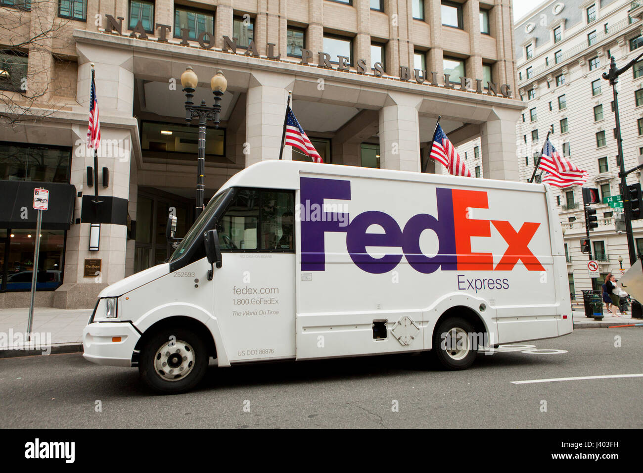 FedEx delivery truck parked in front of office building - USA Stock Photo