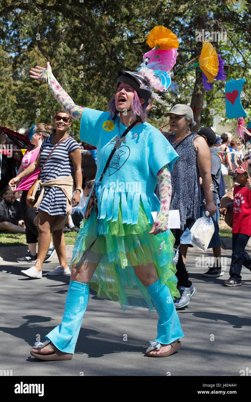 A person in colorful spring colors walking and waving at the Mayday