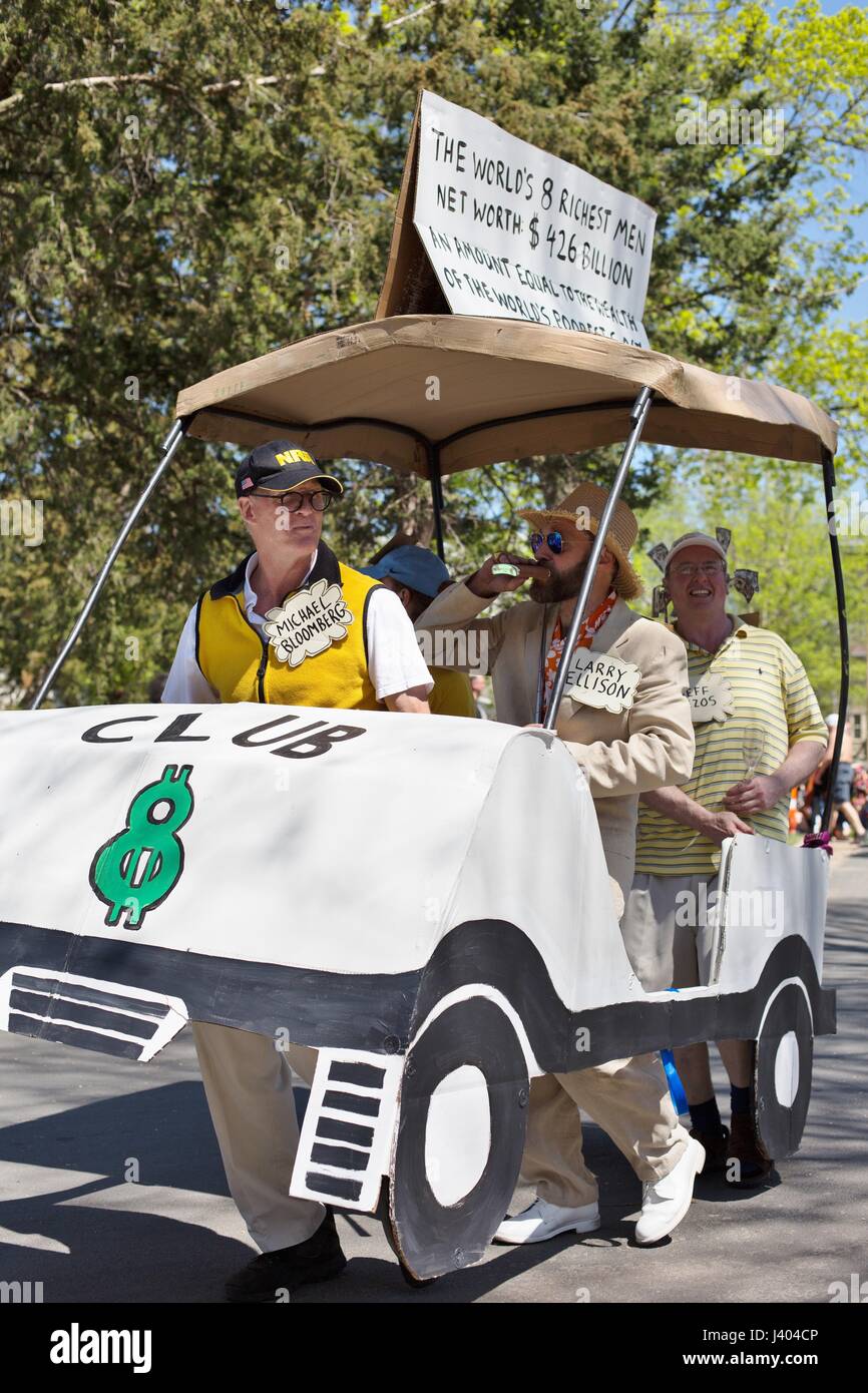 A float representing the world's 8 richest men and protesting the unfair distribution of wealth, at the Mayday parade in Minneapolis, Minnesota, USA. Stock Photo