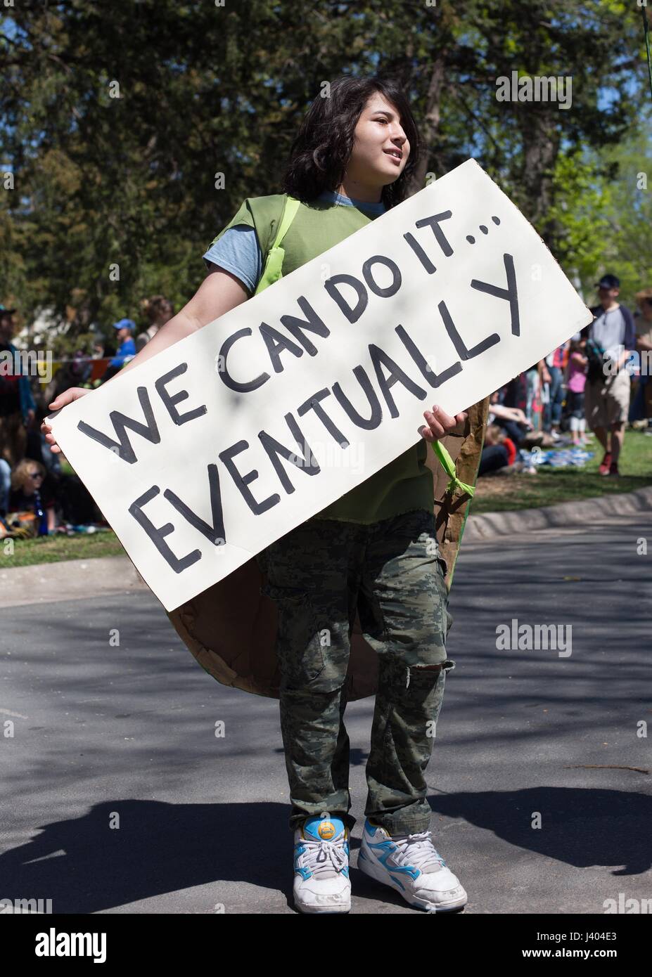 A child carrying a sign reading 