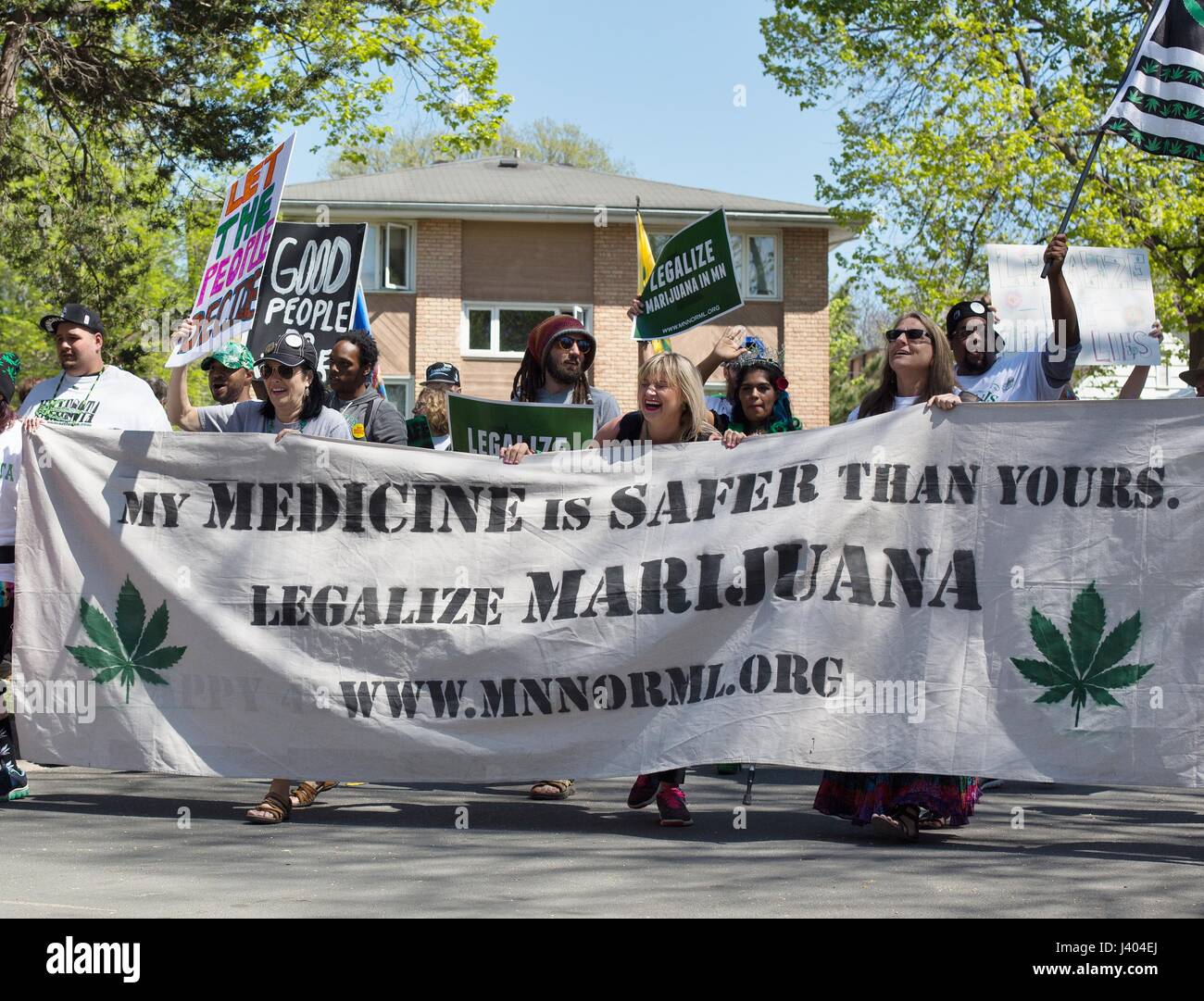 People carrying a banner to legalize marijuana at the Mayday parade in Minneapolis, Minnesota, USA. Stock Photo