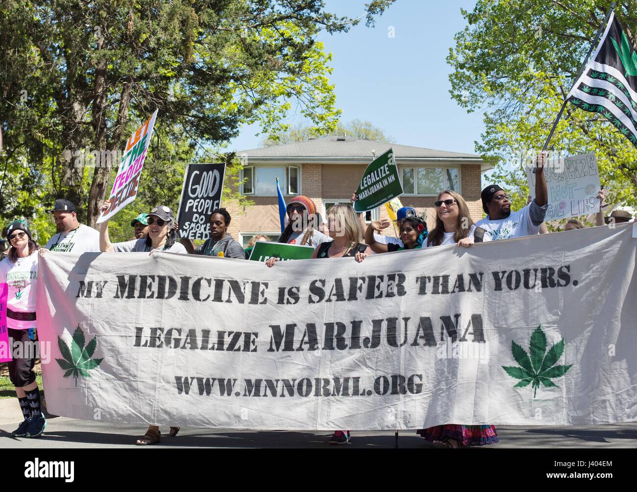 People carrying a banner to legalize marijuana at the Mayday parade in Minneapolis, Minnesota, USA. Stock Photo