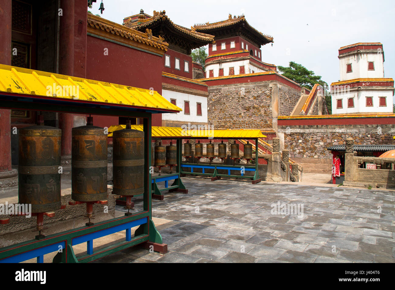 Prayer wheels inside the courtyard of a Tibetan Buddhist Temple in Chengde, China Stock Photo