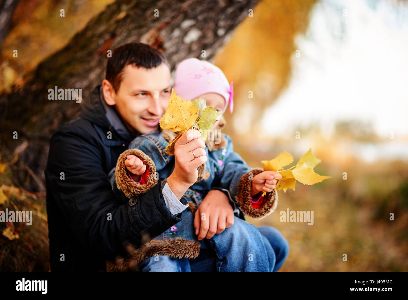 A father with daughter baby in autumn forest Stock Photo - Alamy