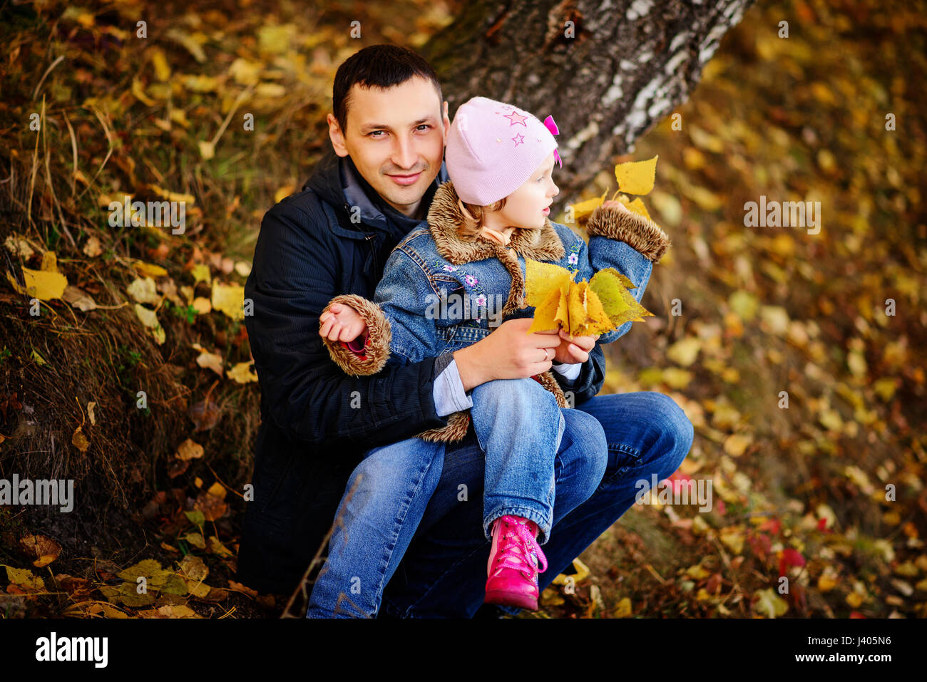 A father with daughter baby in autumn forest Stock Photo - Alamy