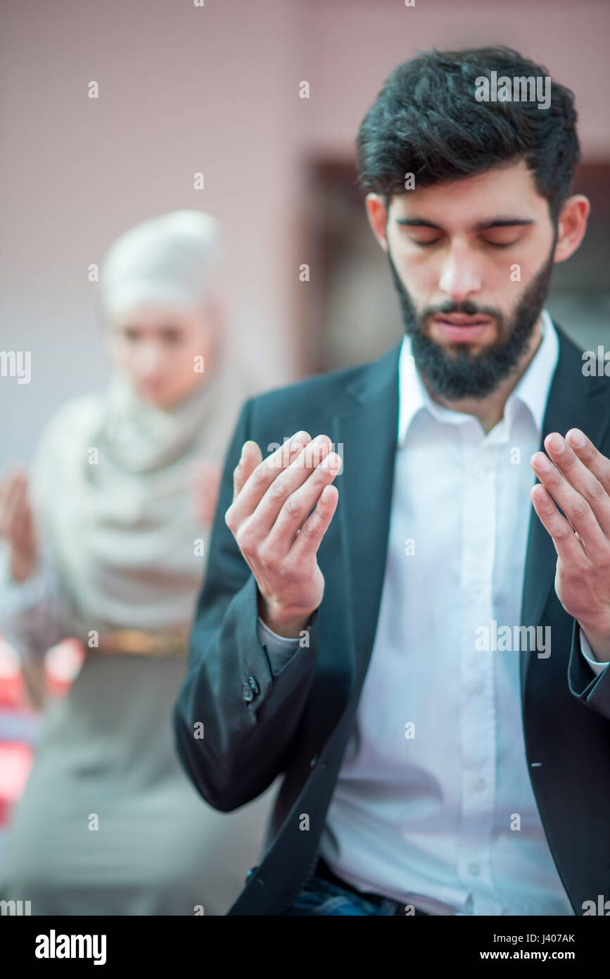Muslim man and woman praying Stock Photo Alamy