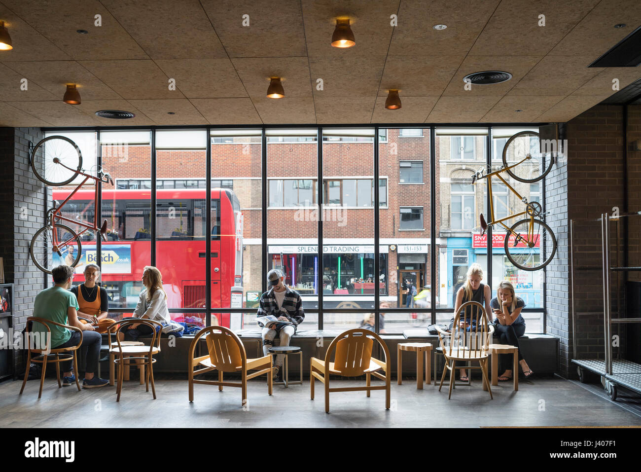 Lobby with window wall and street view. Ace Hotel Shoreditch, London, United Kingdom. Architect