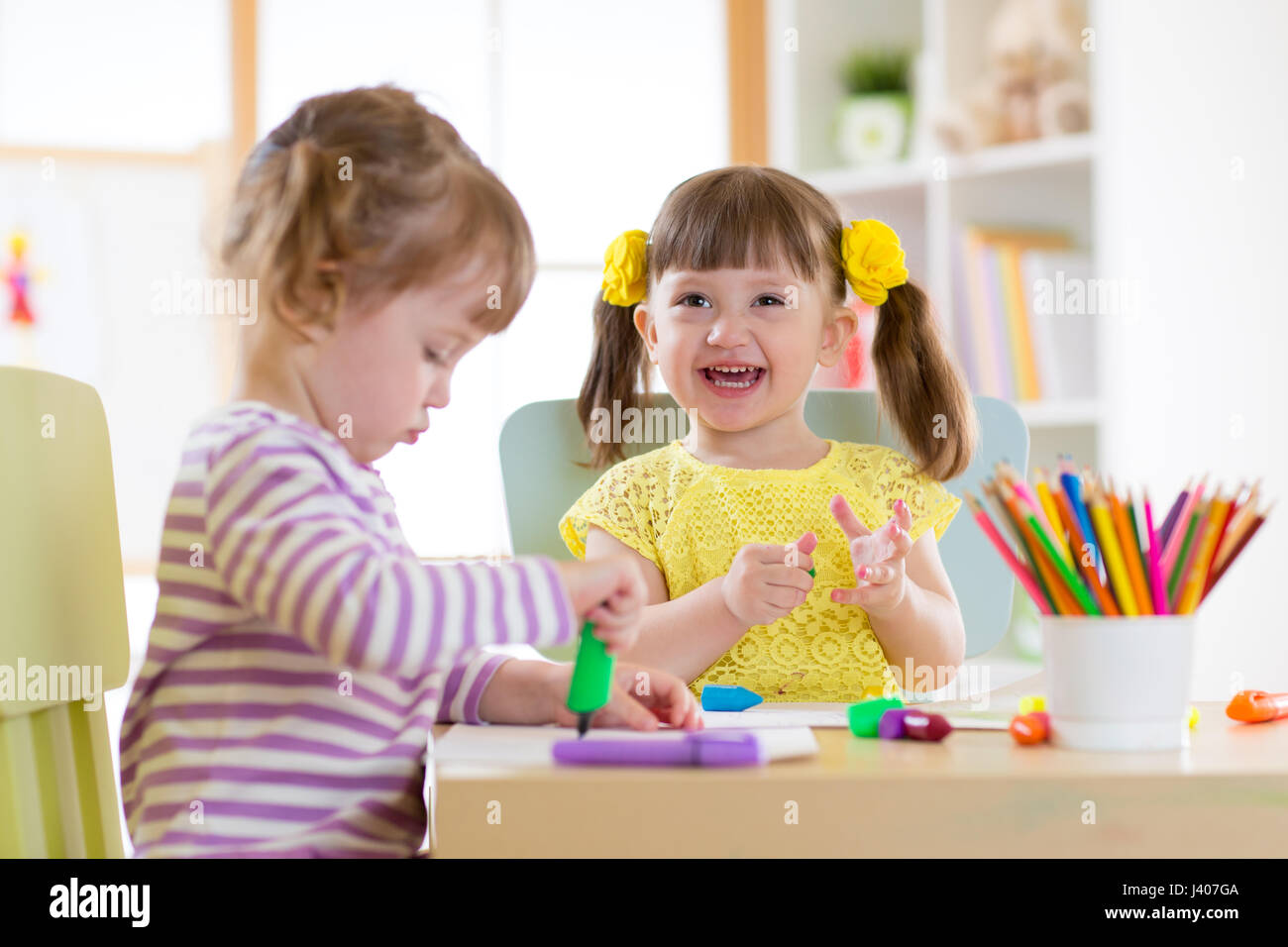 smiling kids painting at home or day care center Stock Photo
