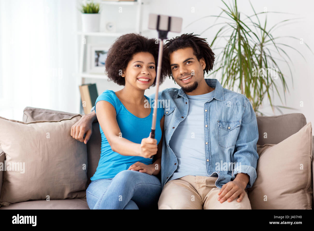 happy couple with smartphone taking selfie at home Stock Photo - Alamy