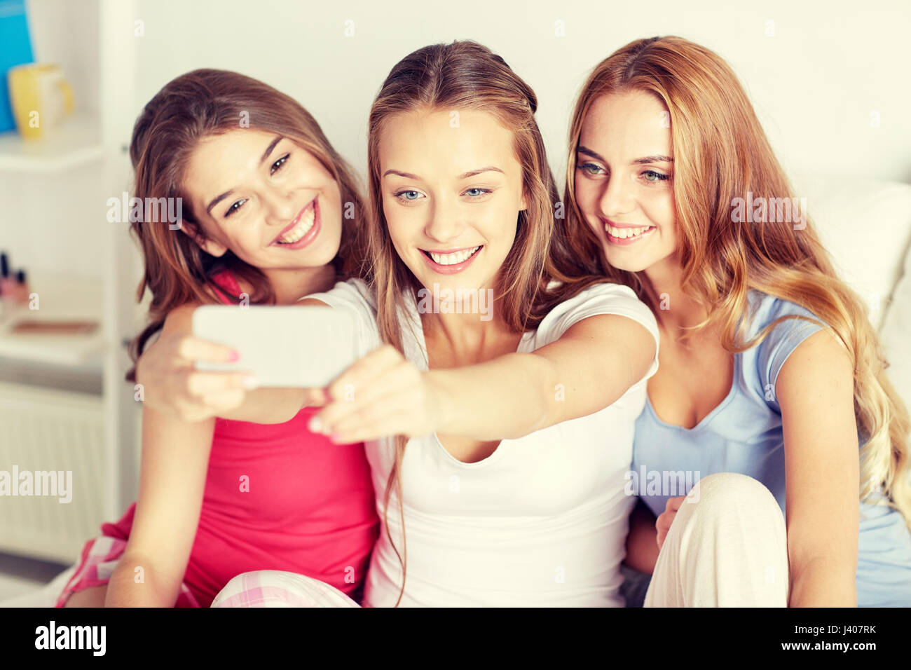 teen girls with smartphone taking selfie at home Stock Photo