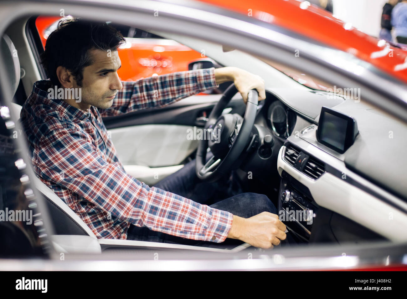 View at young handsome man driving modern car Stock Photo - Alamy