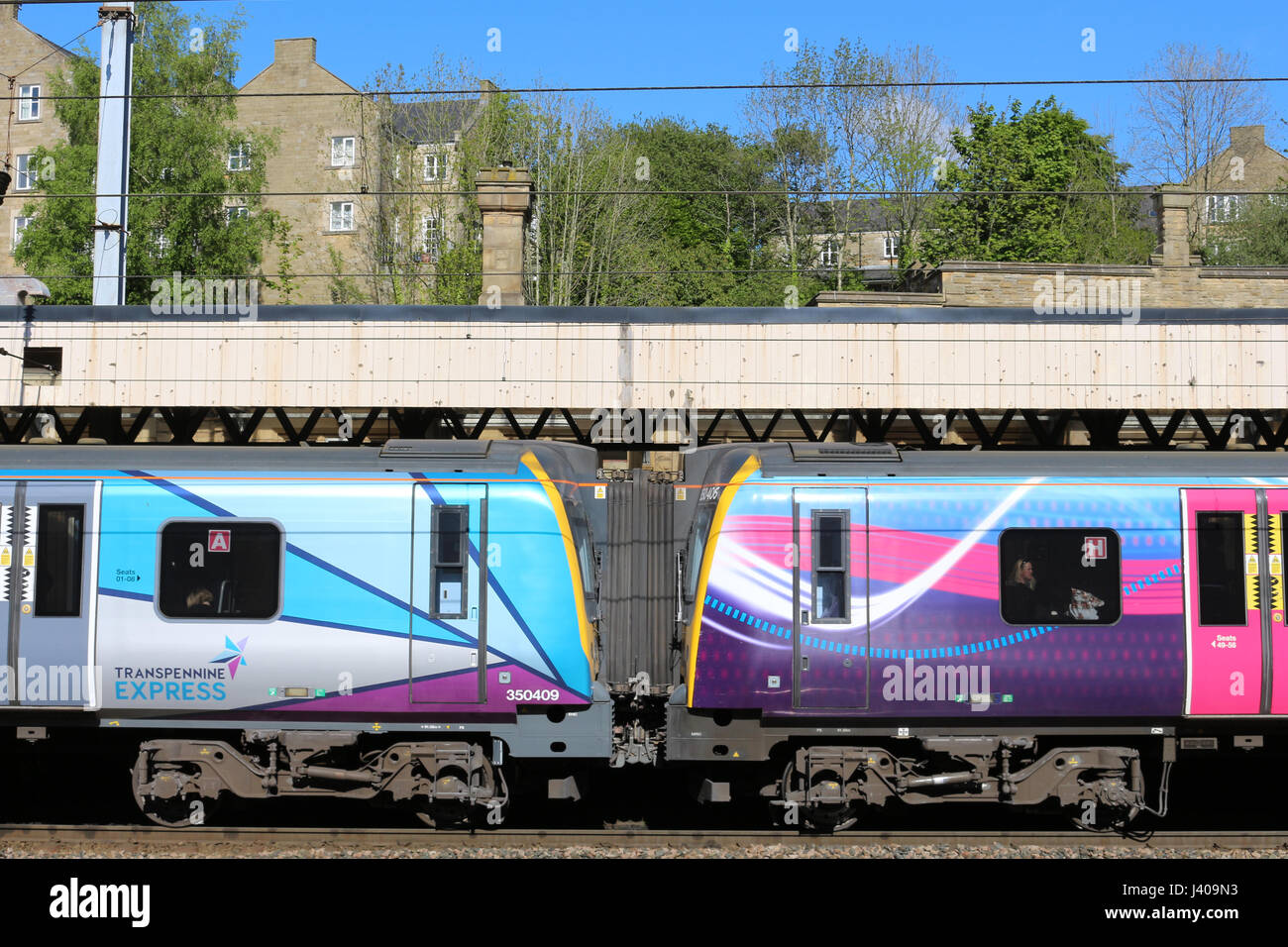 Old and new First Transpennine Express liveries on two class 350 electric trains in platform 4 at Lancaster railway station on West Coast Main Line. Stock Photo