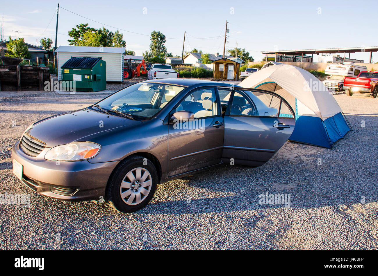 Car parked with camping tent behind in 