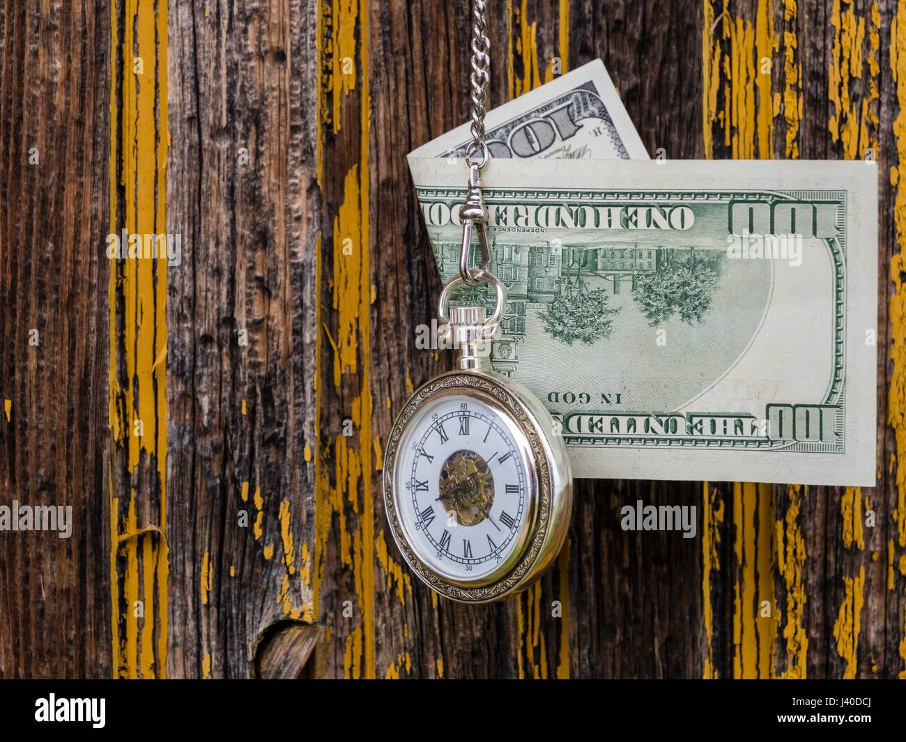 Time is money dollars and vintage pocket watch clock before derelict