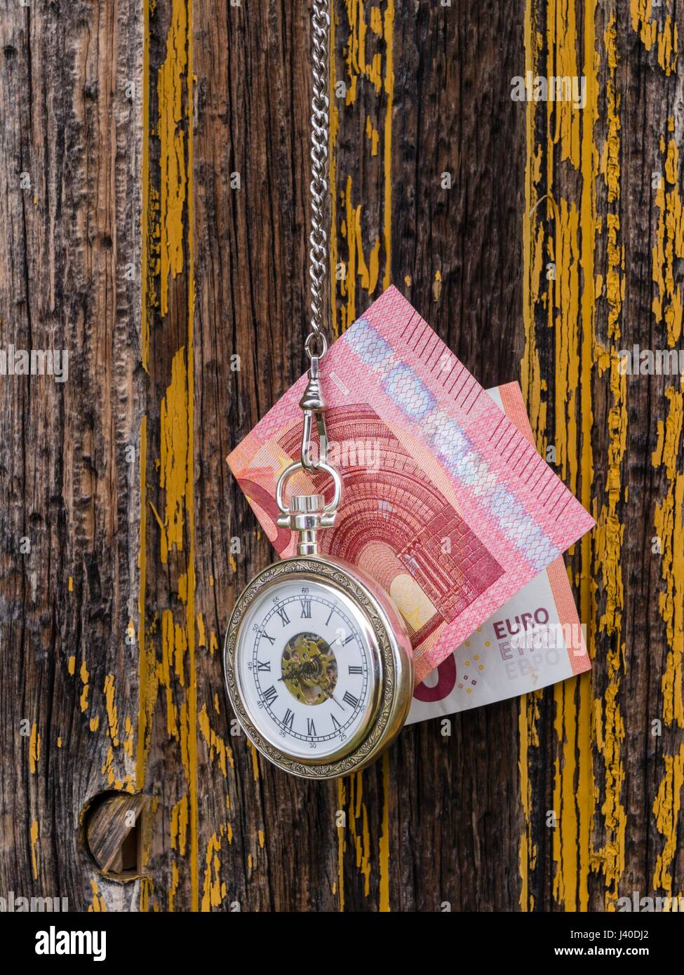 Time is money euro and vintage pocket watch clock before derelict