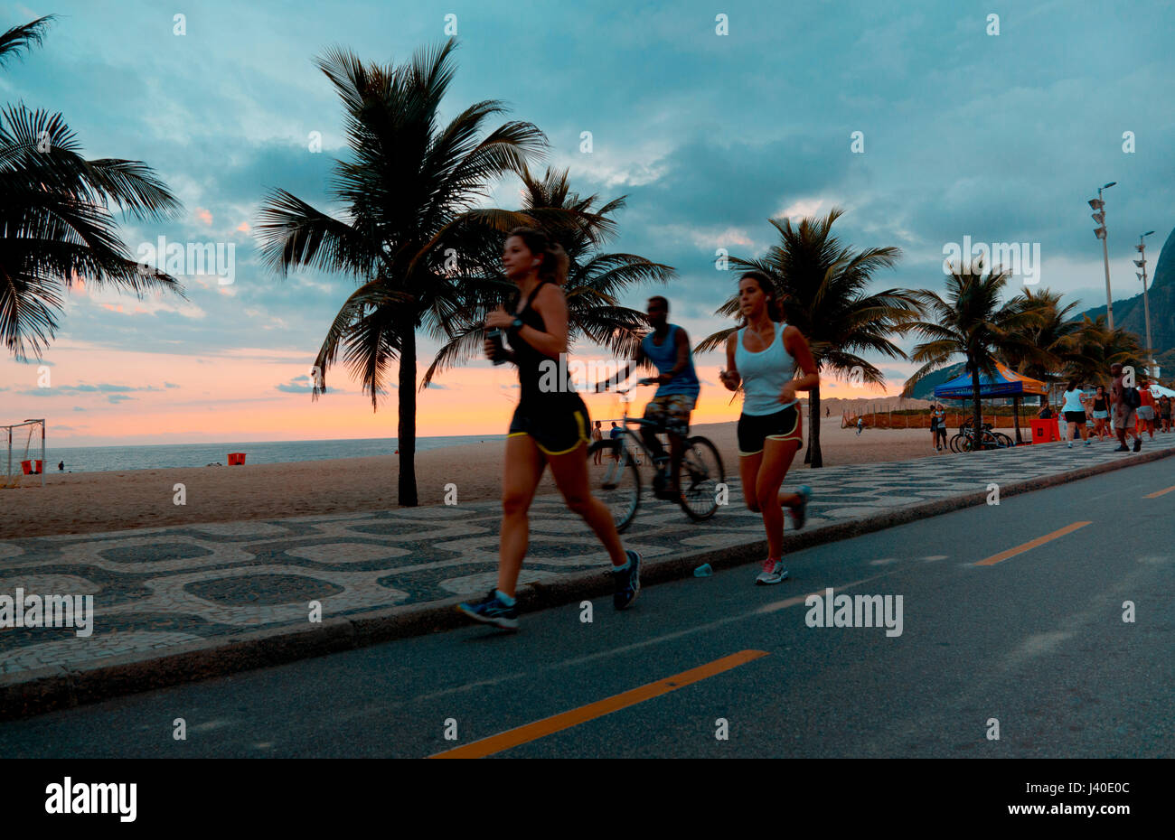 Jogger at the promenade of Ipanema Beach, Rio de Janeiro Stock Photo