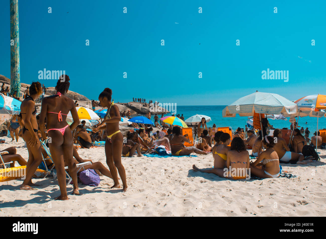sun bathing black girls at Aproador beach, Ipanema, Rio de Janeiro Stock Photo